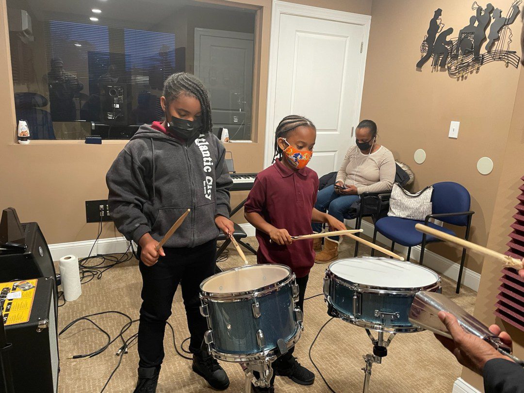 Two kids playing drums